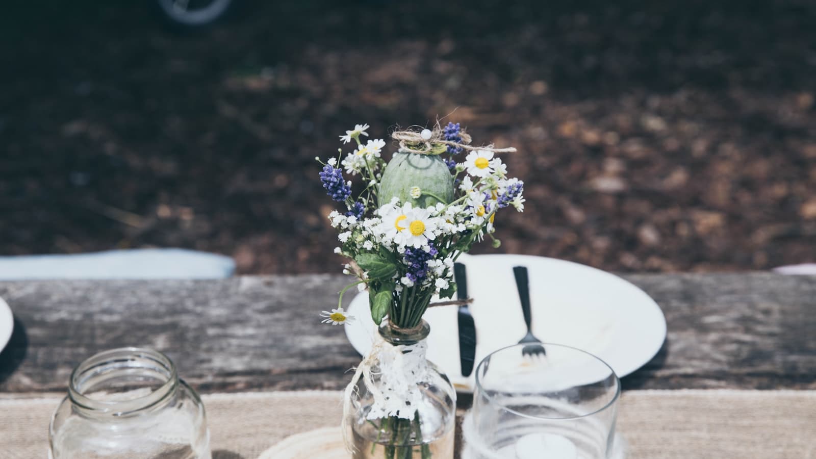 Beautiful simple wedding setup with wildflowers and string lights