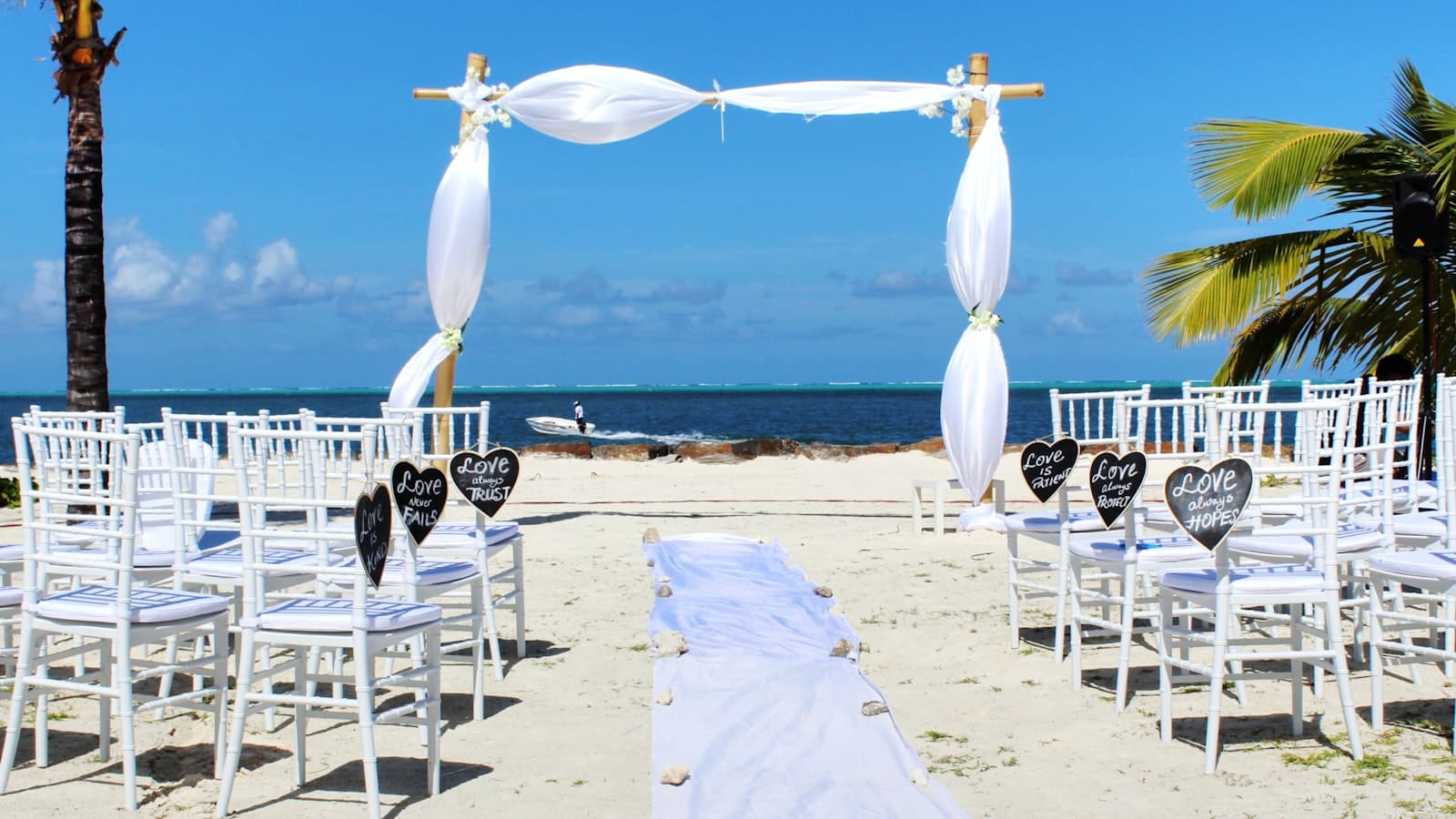 Romantic beach wedding setup with ocean view at sunset